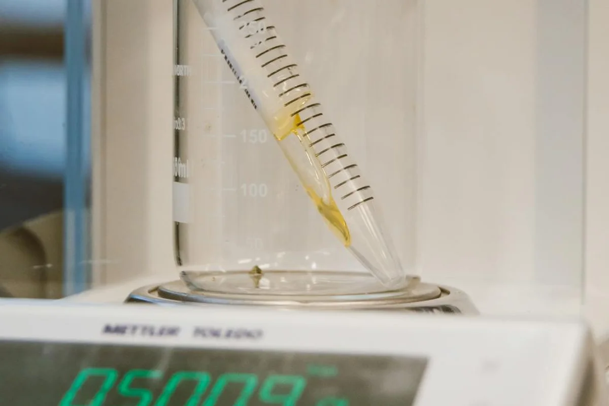 Pipette in a soil-testing setup on a digital scale