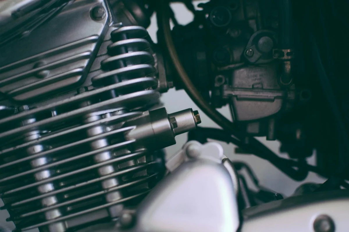 Close-up of a lawn mower engine with a spark plug installed, ready for final checks